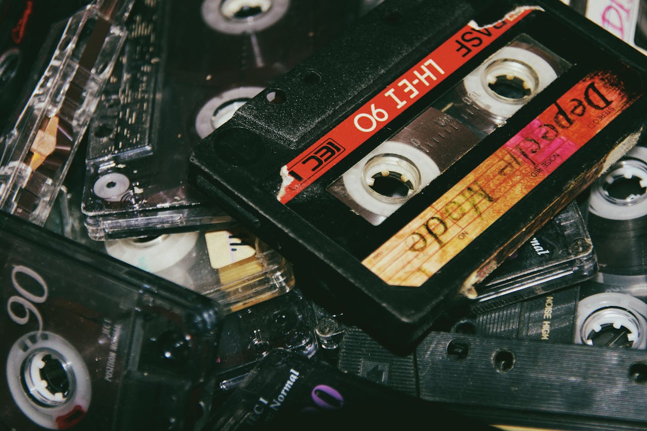 A nostalgic close-up view of a pile of vintage cassette tapes, capturing retro audio media.